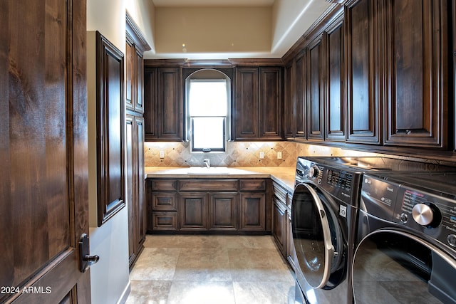 laundry area with cabinets, separate washer and dryer, and sink