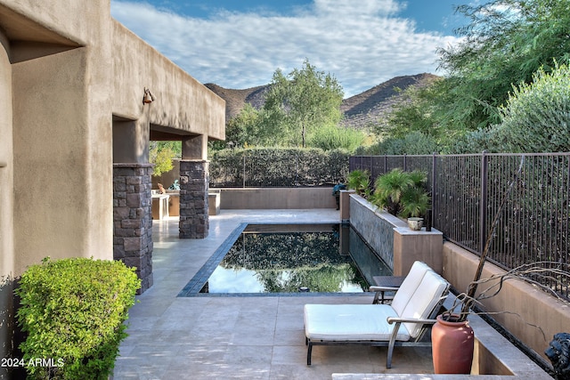 view of patio / terrace featuring a water and mountain view