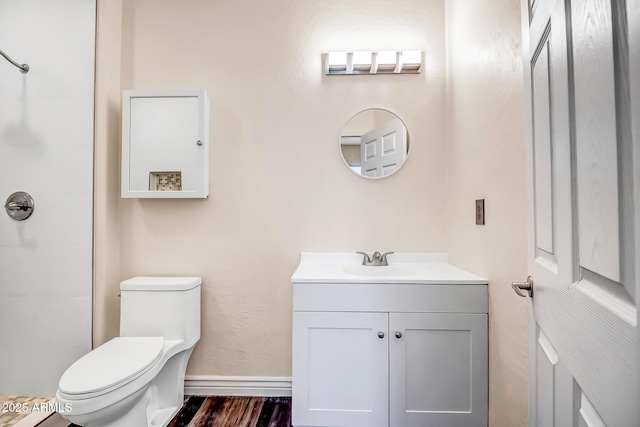 bathroom with vanity, hardwood / wood-style flooring, a shower, and toilet