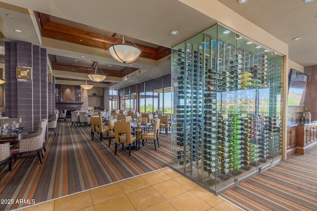 wine cellar featuring tile patterned floors and a raised ceiling