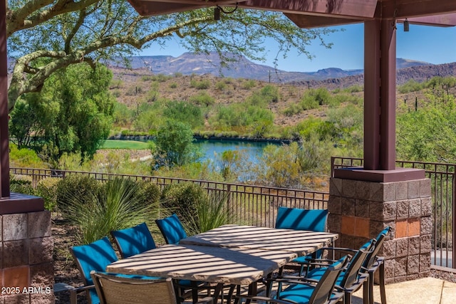 view of patio featuring a water and mountain view