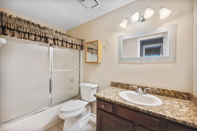 full bathroom featuring tile patterned floors, vanity, enclosed tub / shower combo, and toilet