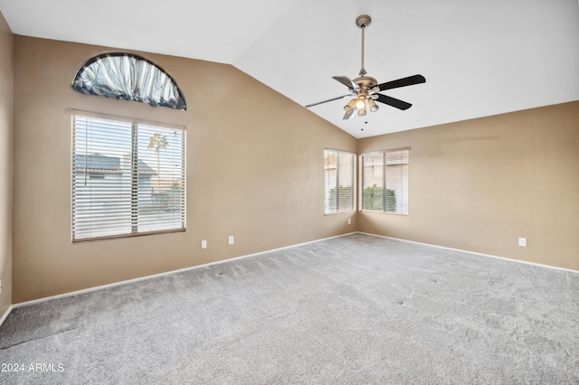 carpeted empty room featuring a healthy amount of sunlight, ceiling fan, and lofted ceiling