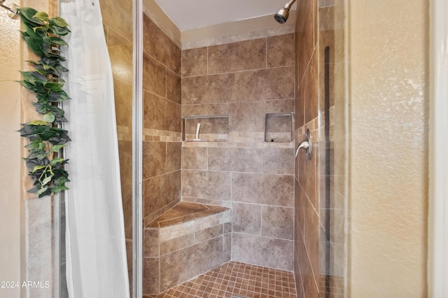 bathroom with a tile shower