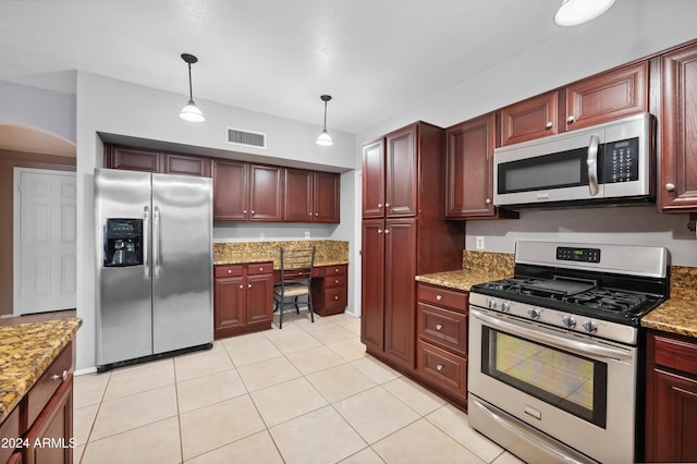 kitchen with light stone countertops, appliances with stainless steel finishes, decorative light fixtures, and light tile patterned floors