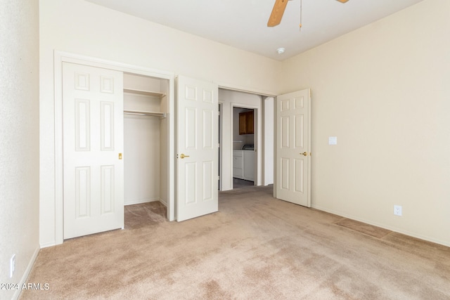 unfurnished bedroom featuring light carpet, a closet, washing machine and dryer, and ceiling fan