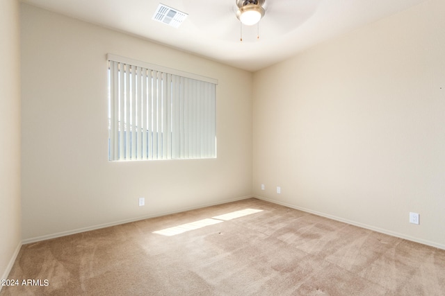 carpeted empty room featuring ceiling fan