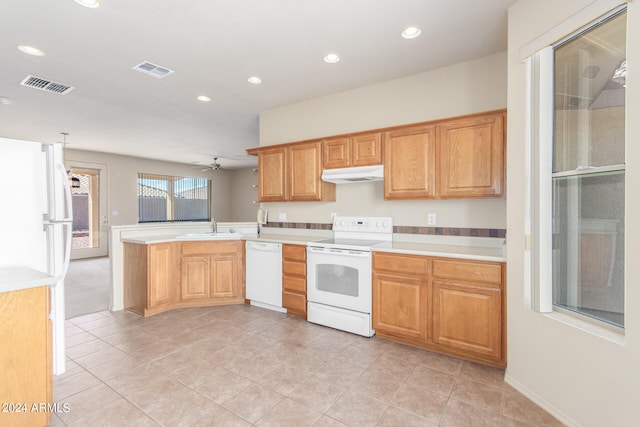 kitchen featuring sink, kitchen peninsula, white appliances, light tile patterned floors, and ceiling fan