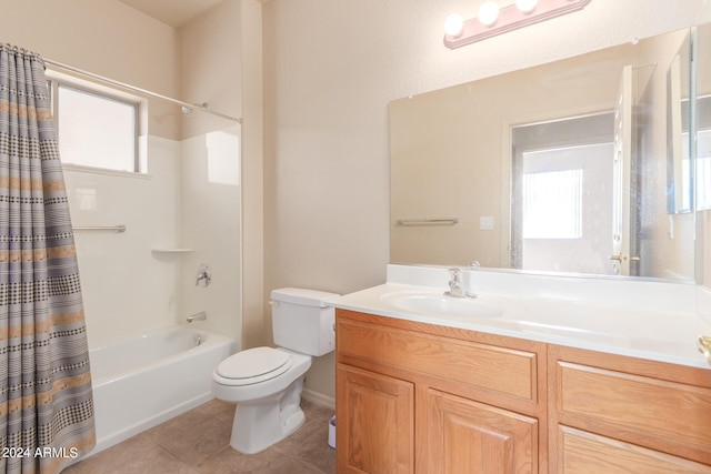 full bathroom with vanity, toilet, shower / bath combo with shower curtain, and tile patterned floors