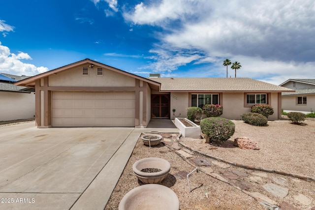 single story home featuring an attached garage, stucco siding, and concrete driveway