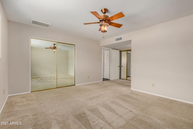 unfurnished bedroom featuring carpet floors, baseboards, and a ceiling fan