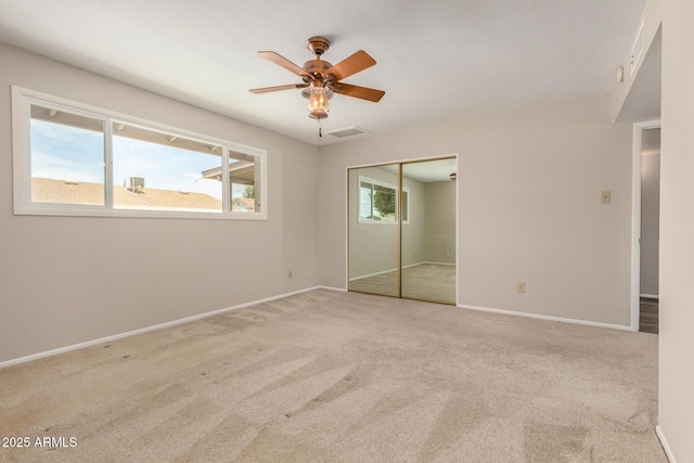 unfurnished bedroom with carpet, baseboards, a closet, and a ceiling fan