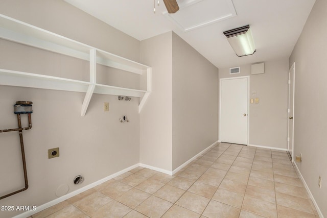 clothes washing area featuring gas dryer hookup, hookup for an electric dryer, light tile patterned floors, baseboards, and attic access
