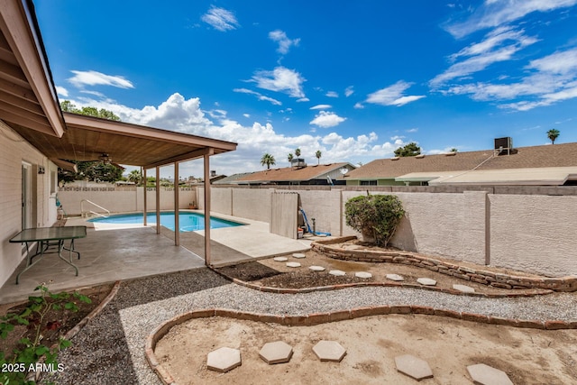 fenced backyard featuring a patio and a ceiling fan