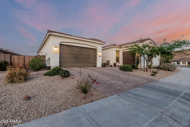 7813 S 43rd Pl, Phoenix, AZ 85042 - mediterranean / spanish home featuring driveway, a garage, stucco siding, and a tile roof