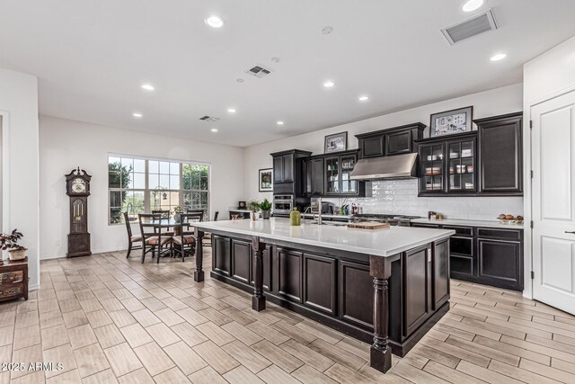 7813 S 43rd Pl, Phoenix, AZ 85042 - kitchen featuring under cabinet range hood, decorative backsplash, light countertops, recessed lighting, and oven