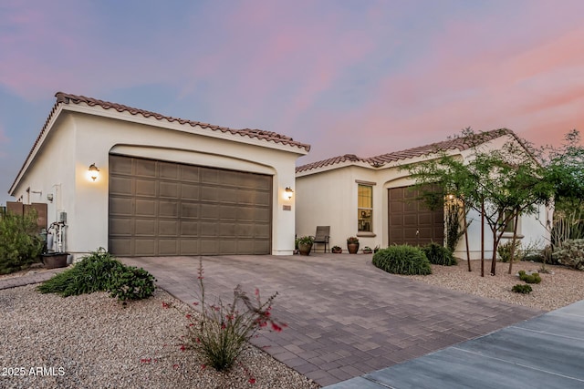 7813 S 43rd Pl, Phoenix, AZ 85042 - mediterranean / spanish house with an attached garage, driveway, stucco siding, and a tile roof