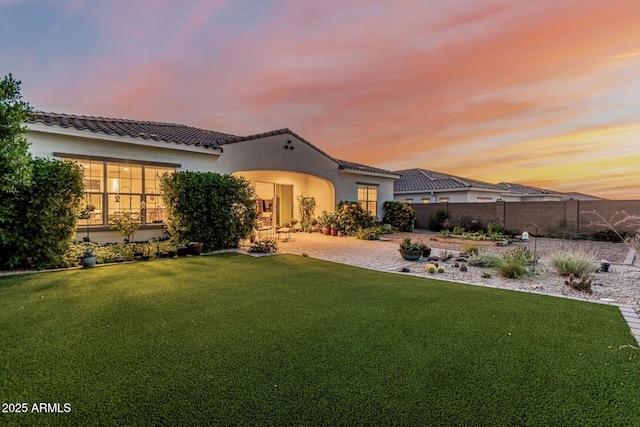 7813 S 43rd Pl, Phoenix, AZ 85042 - back of house with a tiled roof, stucco siding, and a patio area