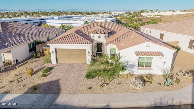 7813 S 43rd Pl, Phoenix, AZ 85042 - mediterranean / spanish-style house featuring an attached garage, stucco siding, driveway, and a tiled roof