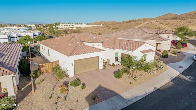 7813 S 43rd Pl, Phoenix, AZ 85042 - view of front of home with an attached garage, stucco siding, driveway, and a tile roof