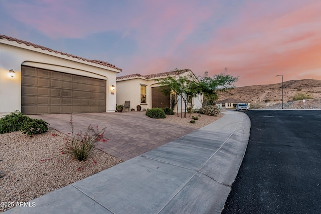 7813 S 43rd Pl, Phoenix, AZ 85042 - mediterranean / spanish home featuring driveway, stucco siding, a garage, and a tiled roof