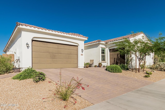 7813 S 43rd Pl, Phoenix, AZ 85042 - mediterranean / spanish home with concrete driveway, a garage, stucco siding, and a tiled roof