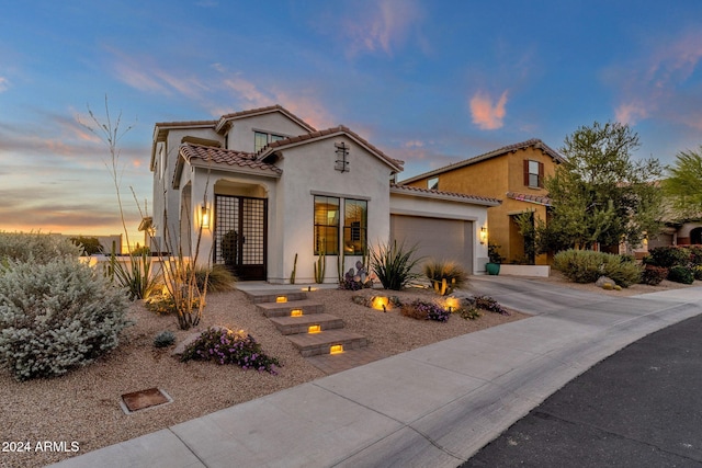 mediterranean / spanish-style house featuring a garage