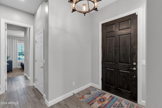 foyer entrance featuring a notable chandelier