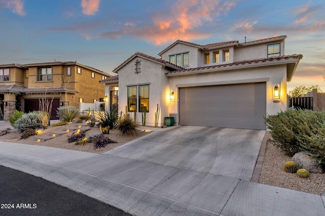 mediterranean / spanish home featuring a garage