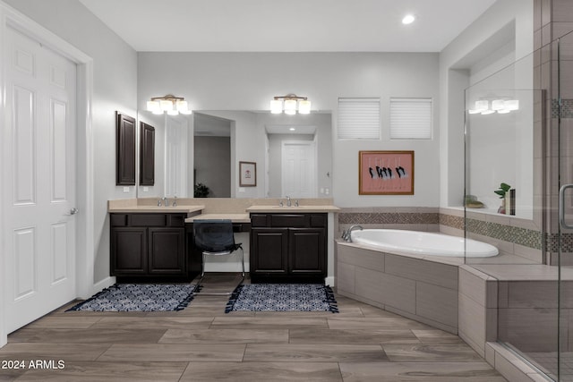 bathroom featuring shower with separate bathtub and vanity