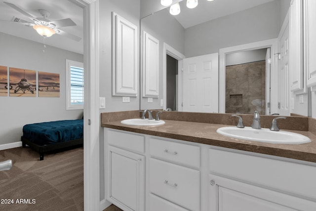 bathroom featuring a shower, vanity, and ceiling fan