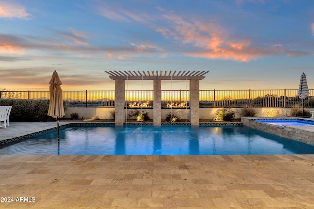 pool at dusk with a pergola, an in ground hot tub, and a patio