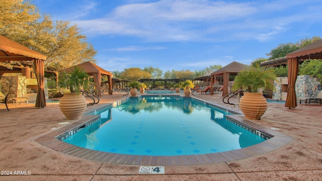 view of swimming pool with a gazebo and a patio