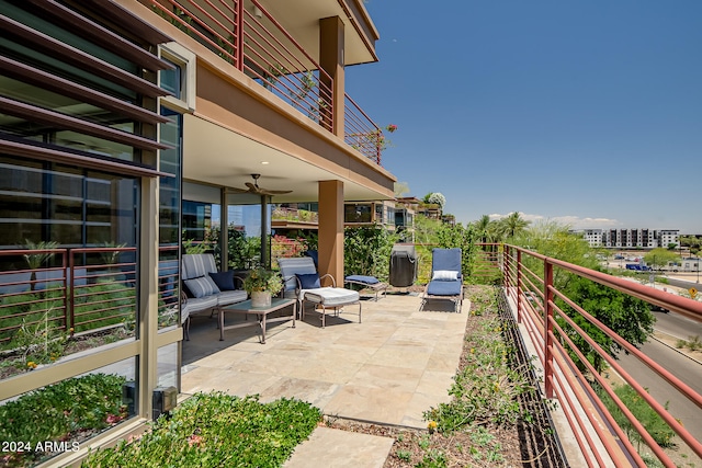 view of patio featuring ceiling fan and a balcony