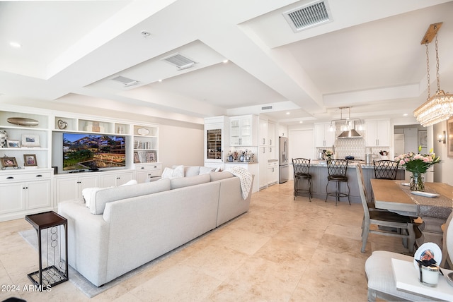 living room featuring a raised ceiling and built in features