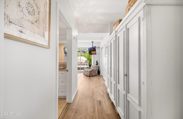 corridor with light hardwood / wood-style flooring