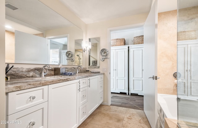 bathroom featuring vanity and a bath