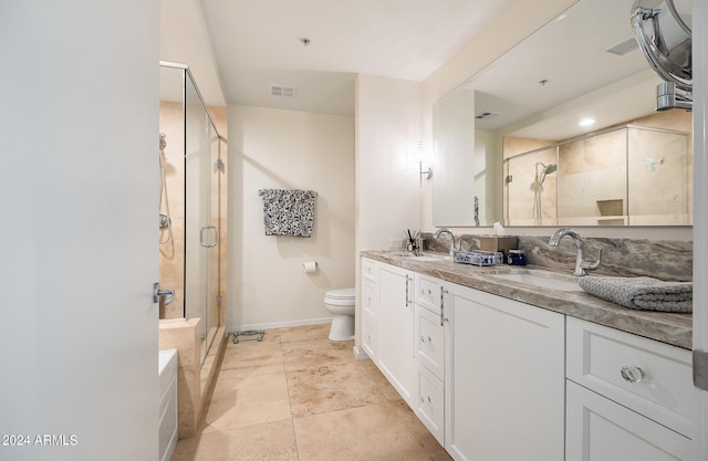 bathroom featuring vanity, toilet, and an enclosed shower