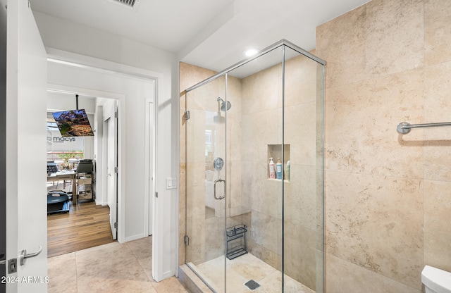 bathroom featuring tile patterned flooring and a shower with door