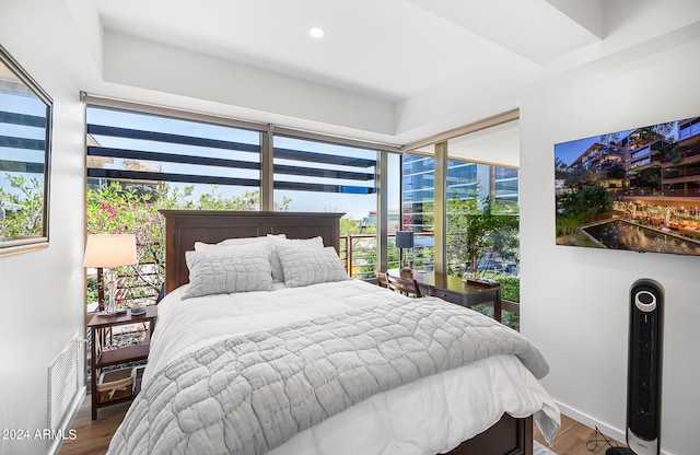 bedroom featuring hardwood / wood-style flooring and multiple windows