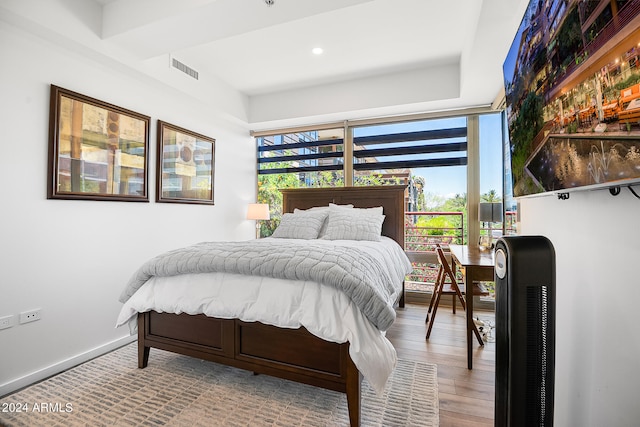 bedroom with hardwood / wood-style flooring