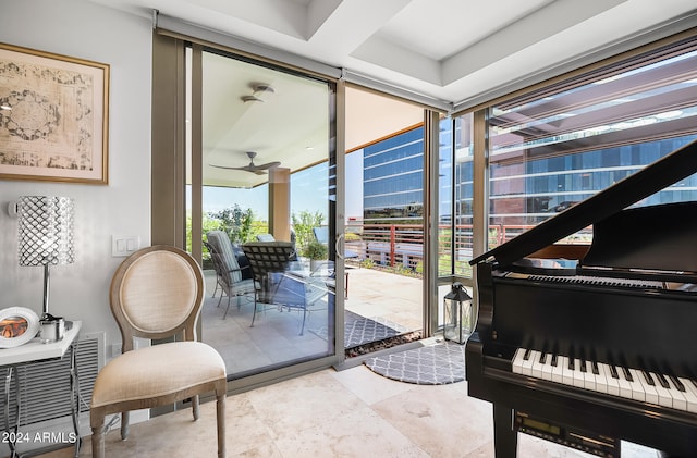 interior space featuring a wall of windows and ceiling fan