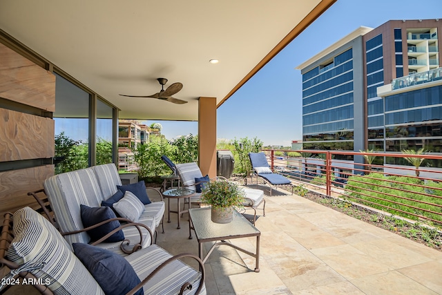 view of patio with outdoor lounge area, ceiling fan, and a balcony