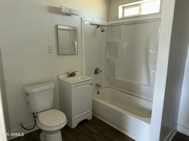 bathroom featuring vanity, toilet, wood finished floors, and shower / bathtub combination