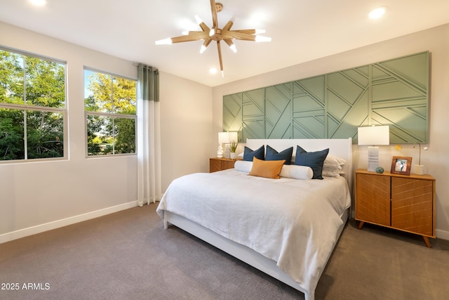 bedroom with ceiling fan and dark colored carpet