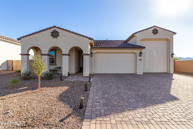 mediterranean / spanish-style house with a garage