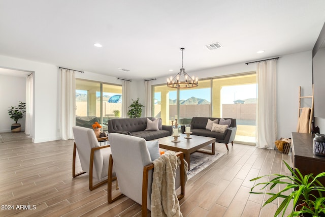 living room with a chandelier, a mountain view, and light hardwood / wood-style floors