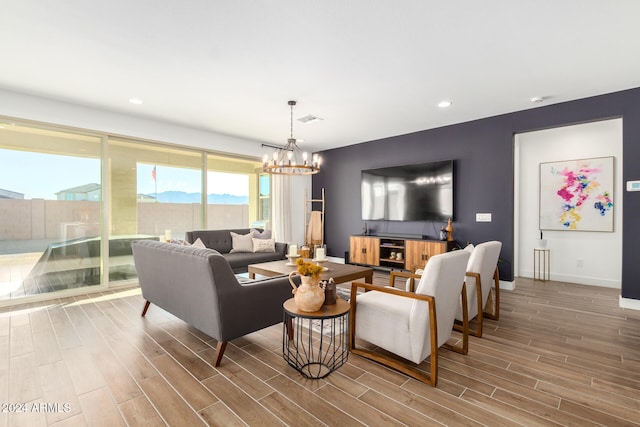 living room with hardwood / wood-style flooring and a notable chandelier