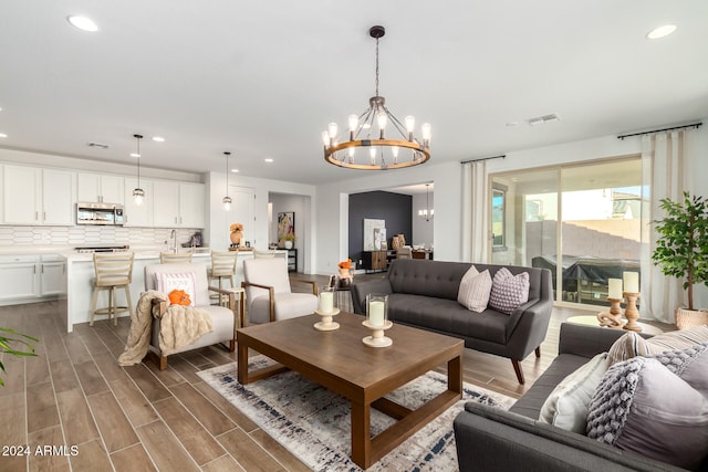 living room with dark hardwood / wood-style floors and a chandelier