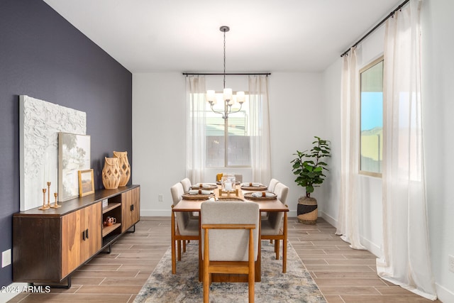 dining room featuring light hardwood / wood-style flooring and an inviting chandelier